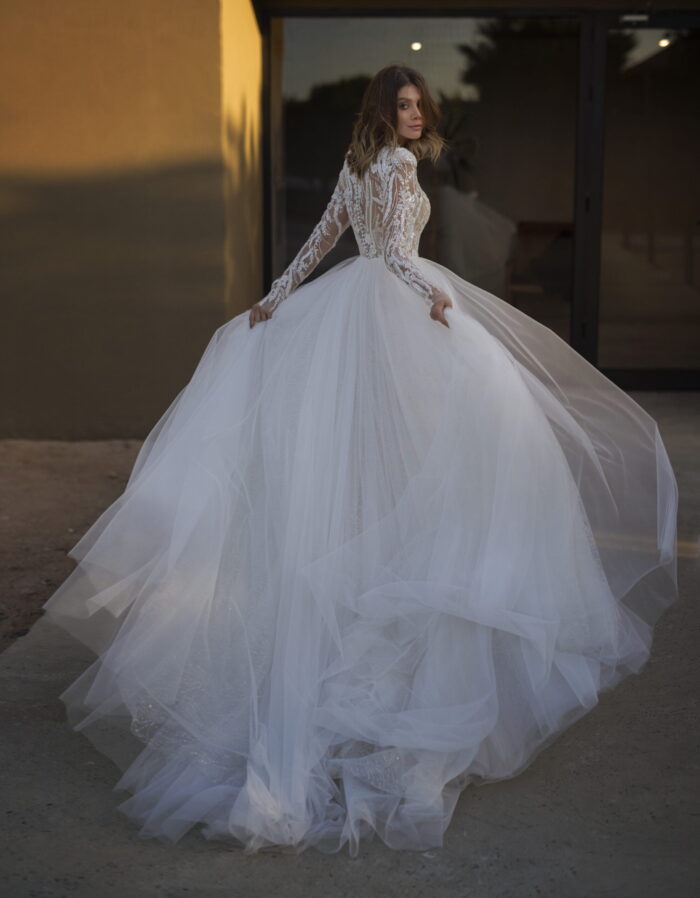 Кармелия 3 Наталья Романова <p style="text-align: justify;">Свадебное платье символизирующее нежность и романтику. Это свадебное платье А-силуэта с длинными рукавами и воротником-стоечкой – истинное воплощение элегантности и изящества. Верх платья полностью выполнен из прекрасного кружева, которое придает ему изысканный и романтический шарм. Каждый узор и цветок кружева с любовью продуман, чтобы подчеркнуть вашу естественную красоту и роскошь. Особенностью этого наряда является спинка на внутреннем корсете со шнуровкой и пуговичками, которые добавляют дополнительно дозу женственности и роскоши. Нежный фатин используется в качестве основного материала, он создает эффект легкости и воздушности, словно вы парите в облаках на своем особенном дне. В этом платье вы будете выглядеть не только красиво, но и поистине принцессой в своей сказке о любви. Оно подарит вам уверенность и элегантность, притягивая все взгляды на вас. С этим платьем ваша свадебная церемония станет запоминающейся и волшебной.</p>
<iframe src="https://www.youtube.com/embed/NLVrAmbC848" width="auto" height="600" frameborder="0" allowfullscreen="allowfullscreen"></iframe>